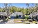 Beautiful single-Gathering home with a well-maintained lawn, a two-car garage and lush landscaping at 12306 Woodlands Cir, Dade City, FL 33525