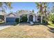Charming single-story home featuring a lush front yard and attached two car garage at 12306 Woodlands Cir, Dade City, FL 33525