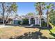 Charming home featuring a well-maintained front yard and a two-car garage at 12306 Woodlands Cir, Dade City, FL 33525