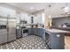 Modern kitchen with stainless appliances, granite counters, and stylish tiled flooring at 12306 Woodlands Cir, Dade City, FL 33525