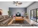 Cozy living room with neutral tones, wood floors, and sliding glass doors to patio at 12306 Woodlands Cir, Dade City, FL 33525