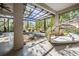 Relaxing screened patio featuring lounge furniture and natural light at 12306 Woodlands Cir, Dade City, FL 33525