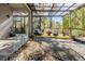 Inviting screened sunroom with comfortable seating and an outdoor fire pit provides a perfect retreat at 12306 Woodlands Cir, Dade City, FL 33525