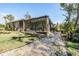 Inviting screened sunroom with comfortable seating and an outdoor fire pit provides a perfect retreat at 12306 Woodlands Cir, Dade City, FL 33525