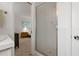 Bathroom with shower and view into bedroom at 1480 Santa Monica Dr, Dunedin, FL 34698