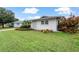 Well-maintained lawn and landscaping in front of the house at 1480 Santa Monica Dr, Dunedin, FL 34698