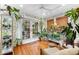 Sunroom filled with plants, featuring hardwood floors and French doors at 151 18Th Ne Ave, St Petersburg, FL 33704