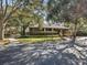 Exterior view of community building with landscaping and paved walkway at 1901 Lennox E Rd # 1901, Palm Harbor, FL 34683