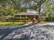 Community clubhouse with landscaping and a paved walkway at 1901 Lennox E Rd # 1901, Palm Harbor, FL 34683