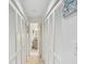 Long hallway with built-in storage and light wood flooring at 1901 Lennox E Rd # 1901, Palm Harbor, FL 34683