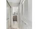 Bright hallway featuring tiled floors, a shower, closet, and vanity in the open bathroom at 1901 Lennox E Rd # 1901, Palm Harbor, FL 34683