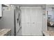 Kitchen with stainless steel refrigerator and pantry doors, offering ample storage space at 1901 Lennox E Rd # 1901, Palm Harbor, FL 34683