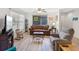 Comfortable living room with wood-look floors, large window, ceiling fan, and plenty of seating options at 1901 Lennox E Rd # 1901, Palm Harbor, FL 34683