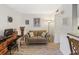 Cozy living room featuring wood-look floors, couch, vintage decor and an 