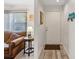 Welcoming entryway next to the living room with new looking paint and floors at 1901 Lennox E Rd # 1901, Palm Harbor, FL 34683