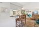 Open concept living room featuring wood-look floors, breakfast bar, and comfortable seating area at 1901 Lennox E Rd # 1901, Palm Harbor, FL 34683