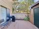 Outdoor patio area features a grill, seating, and a privacy fence for secluded enjoyment at 1901 Lennox E Rd # 1901, Palm Harbor, FL 34683