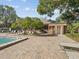 Community pool area with lounge chairs and a nearby building at 1901 Lennox E Rd # 1901, Palm Harbor, FL 34683