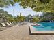 Relaxing community pool with a spa and lounge chairs at 1901 Lennox E Rd # 1901, Palm Harbor, FL 34683