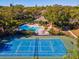 Community pool and tennis court with lounge chairs at 1901 Lennox E Rd # 1901, Palm Harbor, FL 34683