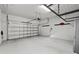 Bright garage interior with overhead storage and Tesla charger at 1913 W North A St # 1, Tampa, FL 33606