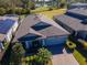 One-story house, gray roof, paved driveway, and a landscaped yard at 19296 Leonard Rd, Lutz, FL 33558