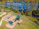 playground with shaded areas and modern equipment near a lake at 19296 Leonard Rd, Lutz, FL 33558