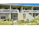 Two-story building with balconies and a landscaped yard at 20853 Haulover Cv # A8, Lutz, FL 33558