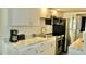 Efficient galley kitchen features granite countertops and stainless steel appliances at 20853 Haulover Cv # A8, Lutz, FL 33558