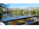 Peaceful lake view with a bench and trees at 20853 Haulover Cv # A8, Lutz, FL 33558