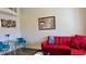 Living room featuring a red couch and teal accent chairs at 20853 Haulover Cv # A8, Lutz, FL 33558