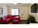 Living room with red sectional sofa and large TV at 20853 Haulover Cv # A8, Lutz, FL 33558