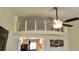 Charming loft bedroom with ceiling fan and glass railing at 20853 Haulover Cv # A8, Lutz, FL 33558