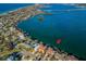 Aerial view of a waterfront property with a private dock and boat lift, surrounded by serene blue waters at 308 Harbor Dr, Indian Rocks Beach, FL 33785