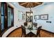 Charming dining room with hardwood floors, round table, and bamboo ceiling at 308 Harbor Dr, Indian Rocks Beach, FL 33785