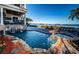 Stunning pool area with a spa, waterfall and beautiful water views at 308 Harbor Dr, Indian Rocks Beach, FL 33785