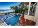 Inviting saltwater pool with waterfall feature and lush landscaping at 308 Harbor Dr, Indian Rocks Beach, FL 33785