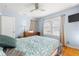 Bedroom with hardwood floors, two windows, and a ceiling fan at 308 Pennsylvania Ave, Clearwater, FL 33755