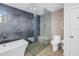 Modern bathroom with soaking tub, glass shower, and gray tile at 323 30Th N Ave, St Petersburg, FL 33704