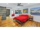 Bedroom with red bedding, wood floors, and barn door at 323 30Th N Ave, St Petersburg, FL 33704