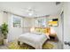 Virtually staged bedroom with yellow accents and a large TV at 3529 Windham Dr, Holiday, FL 34691