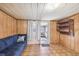 Cozy living room with wood-paneled walls and tiled flooring at 3529 Windham Dr, Holiday, FL 34691
