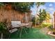 Backyard area featuring a seating area with outdoor furniture, green turf, privacy fence, and garden decor at 3529 Windham Dr, Holiday, FL 34691