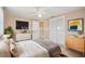 Staged bedroom with neutral tones, wood-look floors, and modern decor at 3529 Windham Dr, Holiday, FL 34691