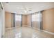 Bright bedroom with tile flooring, two windows with curtains, and a ceiling fan at 3529 Windham Dr, Holiday, FL 34691