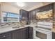 Close-up of kitchen featuring granite countertops, tile backsplash, and modern appliances at 3529 Windham Dr, Holiday, FL 34691