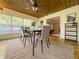 Bright dining area with wood ceiling, large windows, and view into living room at 3611 8Th N St, St Petersburg, FL 33704