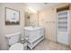 Bathroom with double vanity, toilet, and linen storage at 399 2Nd St # 718, Indian Rocks Beach, FL 33785