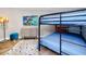 Cozy bedroom with a bunk bed, colorful rug, and modern wood cabinet at 399 2Nd St # 718, Indian Rocks Beach, FL 33785