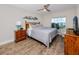 Bedroom with a queen bed, wood dresser, and large window with water views at 399 2Nd St # 718, Indian Rocks Beach, FL 33785